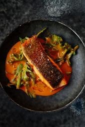 Trout with Smoked Fish Banga. Tender trout infused with smoky, nutty Banga flavors and rich palm fruit sauce, offering a balanced blend of earthy, savory, and sweet notes. (₩30,000)