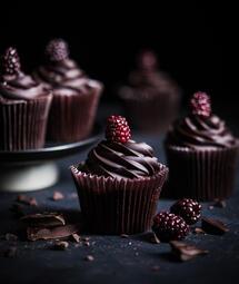 Dark Choco Berry Cupcake. A rich, moist dark chocolate cupcake filled with sweet, tangy berries, offering a perfect balance of bittersweet chocolate and fresh fruit in every bite. (₩5,000)