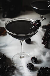 Noir Signature: Black Widow. The Black Widow blends blackcurrant liqueur, vodka, and Kahlua for a bold, sweet, and warming cocktail with a touch of bitterness. (₩20,000)
